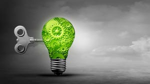 Lightbulb containing green gears against a gray backdrop.