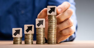 hand stacking coins in ascending order