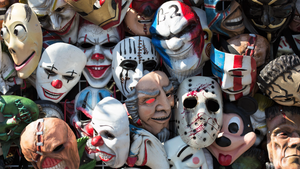 A jumble of scary Halloween masks for sale 